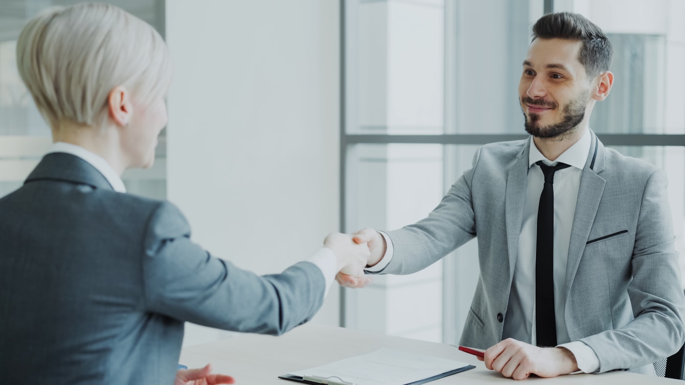 Recruiter and candidate shaking hands after a successful placement